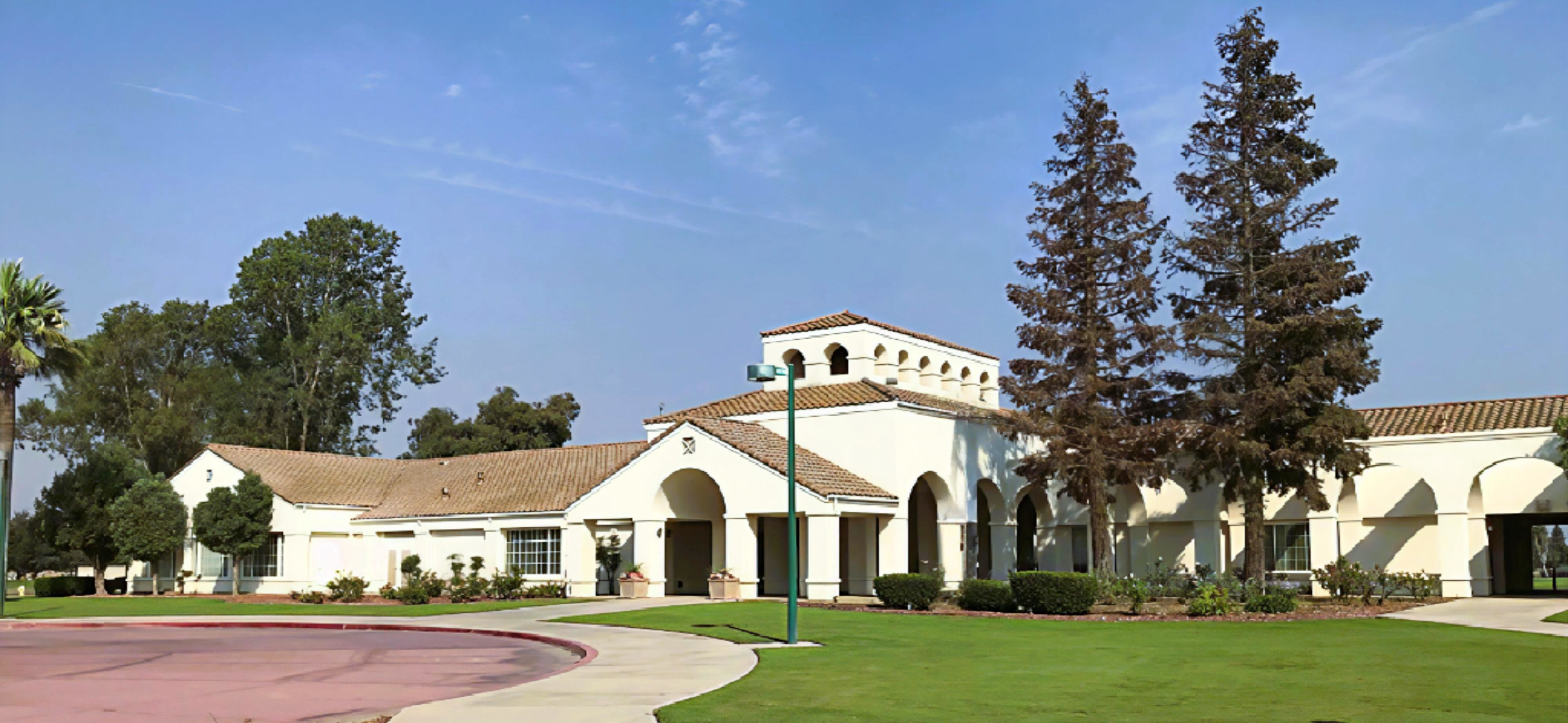 The Spanish mission-style clubhouse at Madera Municipal Golf Course on a clear morning